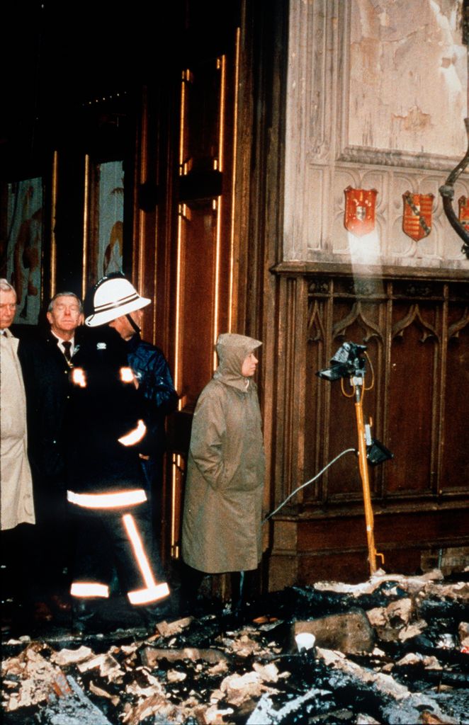 The Queen and a fireman surverying damage at Windsor Castle