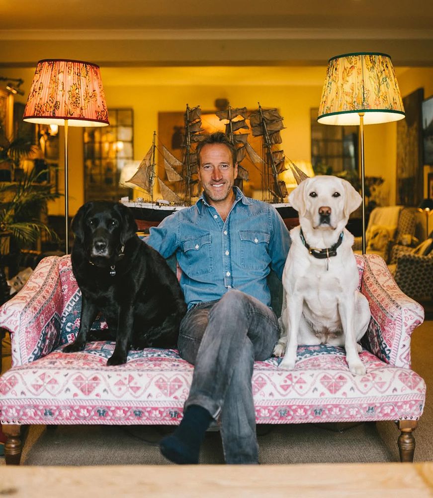 Ben Fogle in his living room with two of his dogs on the sofa