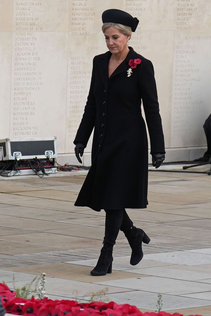 Sophie wearing  black dress and hat