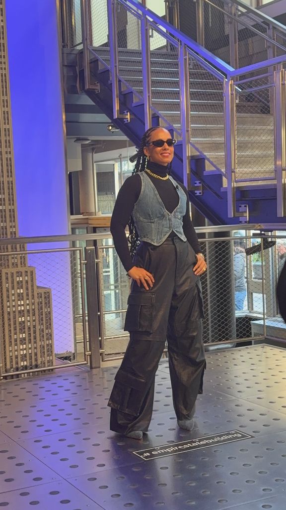 Alicia Keys poses at the Empire State Building to celebrate the one year anniversary of Hell's Kitchen on Broadway