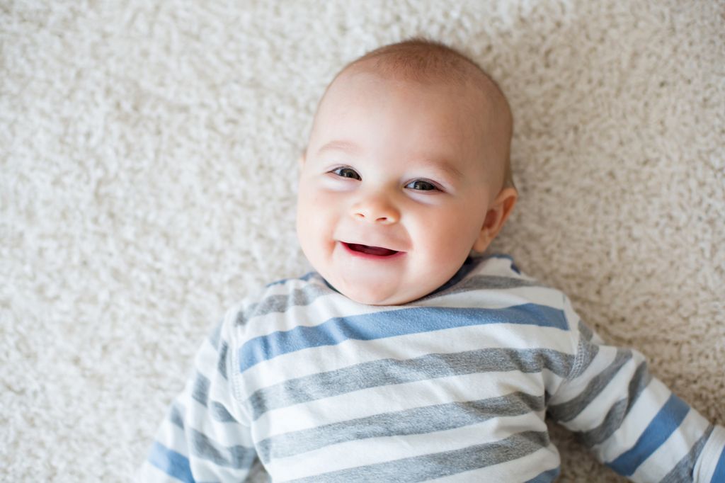 Cute portrait of toddler baby boy in sunny roomm sweet baby boy, smiling at camera, close portrait