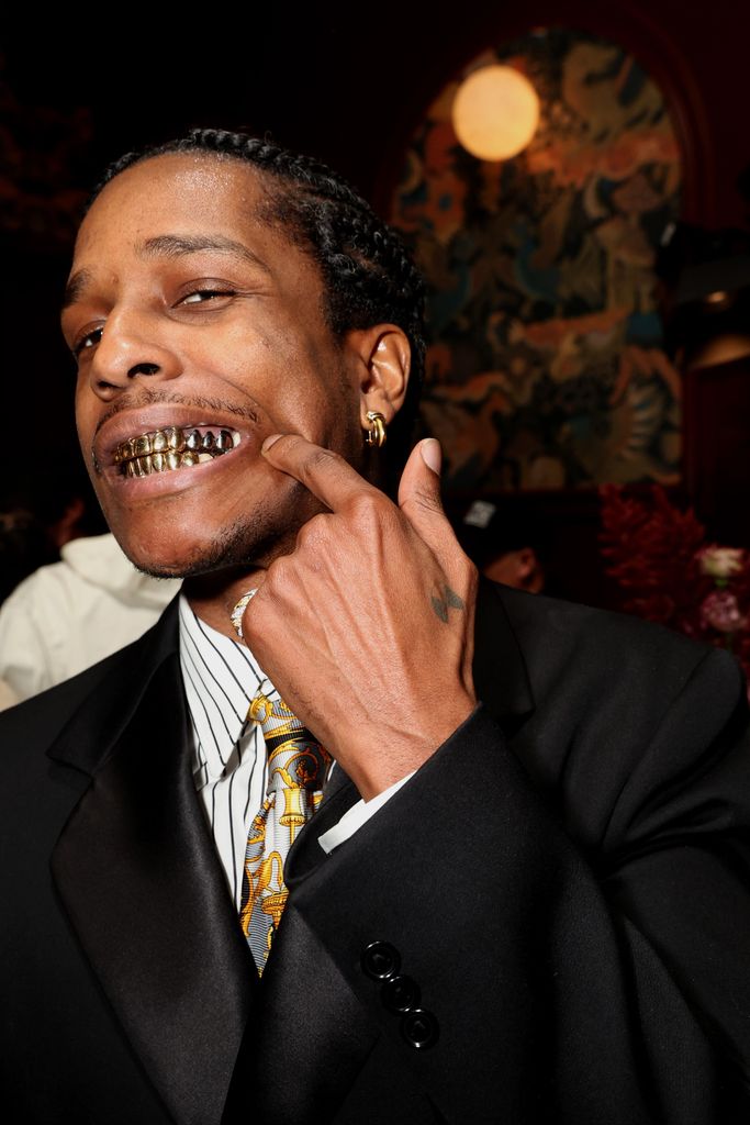 asap rocky wearing gold grills on his teeth