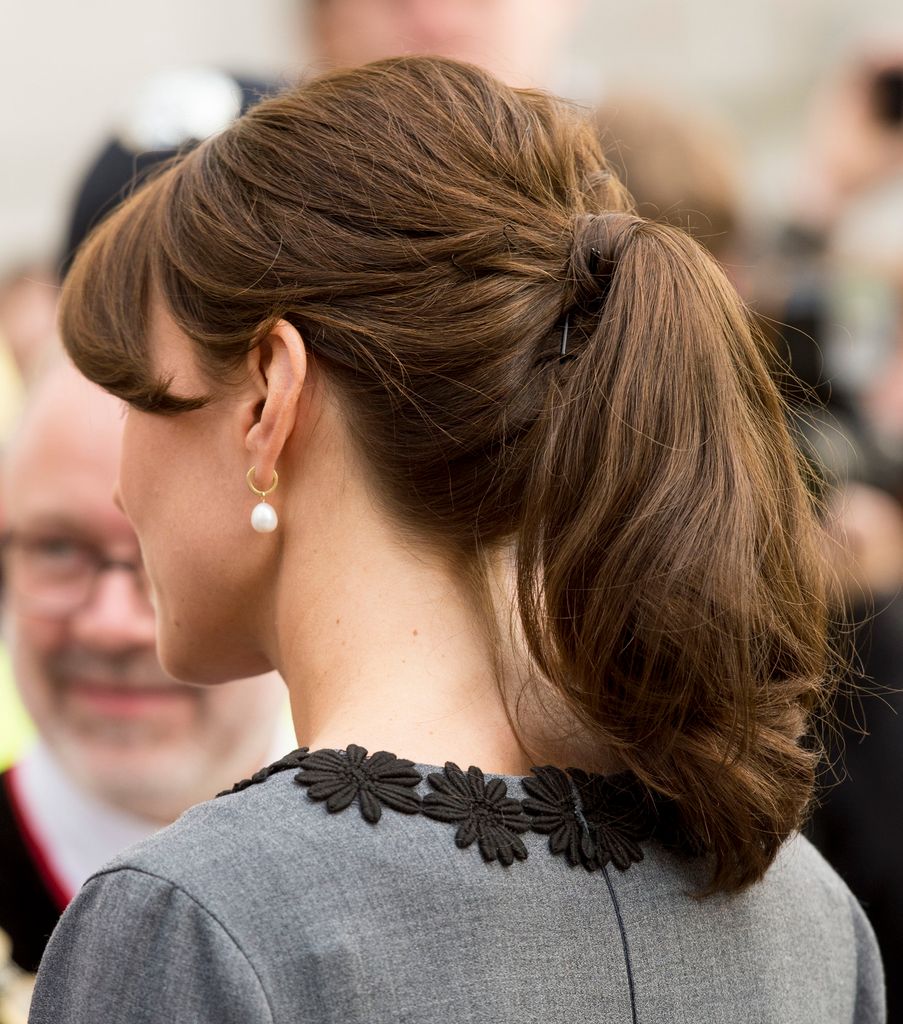 Catherine, Princess of Wales wears her hair in a ponytail to meets children and mentors from Chance UK's Early Intervention Programme at Islington Town Hall on October 27, 2015 in London, England.