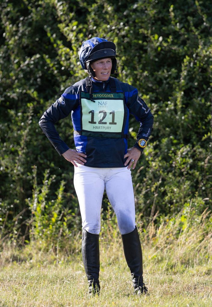 Zara Tindall wears a riding helmet and boots with white johdpurs 