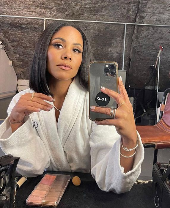 Alex Scott looking at a mirror whilst showing off her new short hair