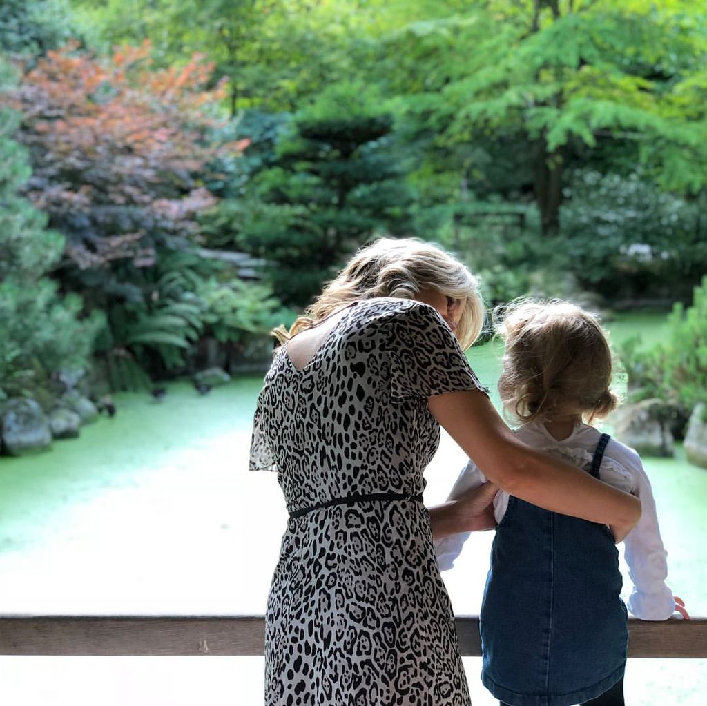 Charlotte Hawkins in a leopard print dress with her arm around daughter Ella Rose