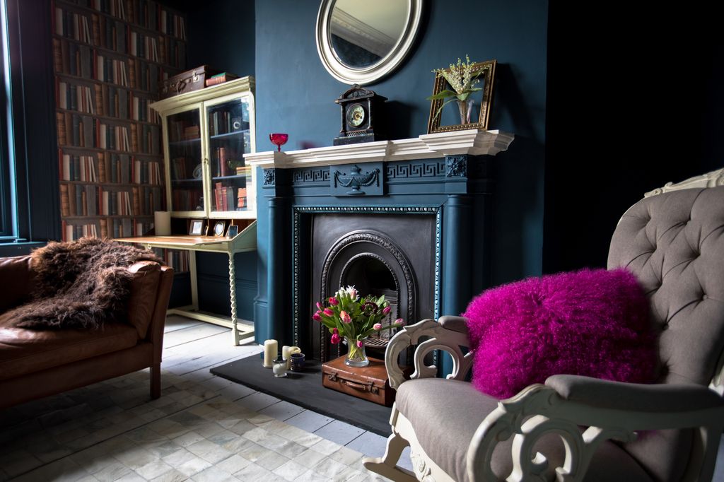 maximalist interior design in living room with blue fireplace and architectural features