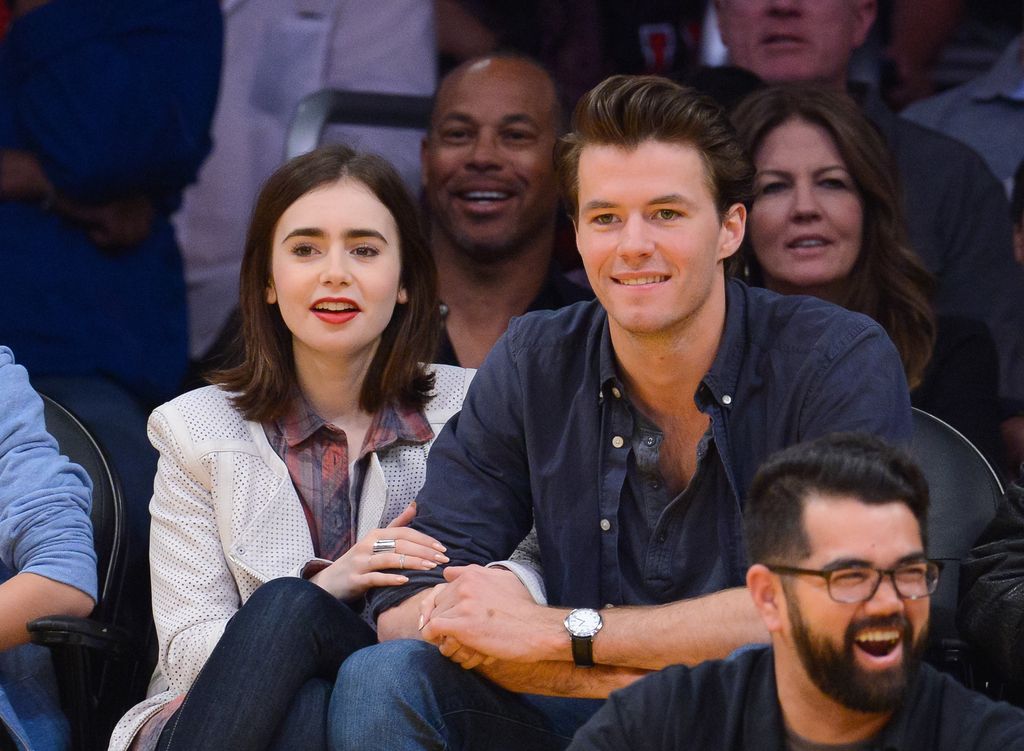 Lily Collins and Thomas Cocquerel sit at LA Lakers Game in 2014