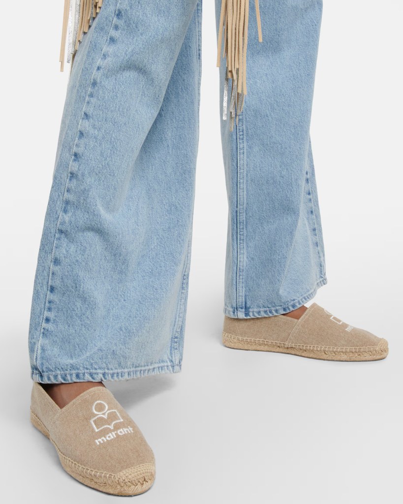 A model poses in jeans and a pair of Isabel Marant beige shoes