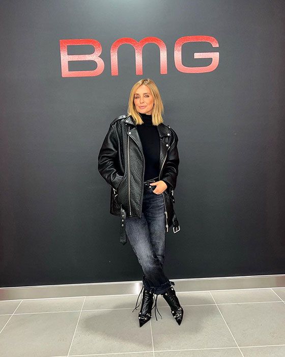 Louise Redknapp posing in front of a BMG sign after signing with them