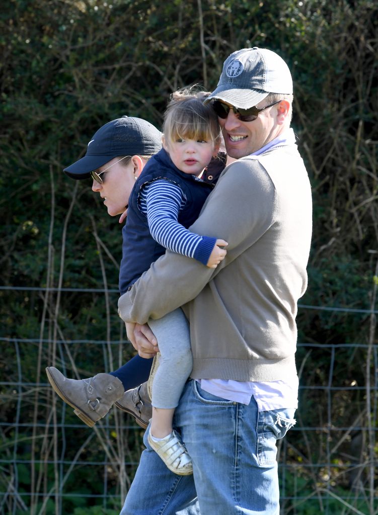 Peter Phillips holding Mia during Gatcombe Park Horse Trials