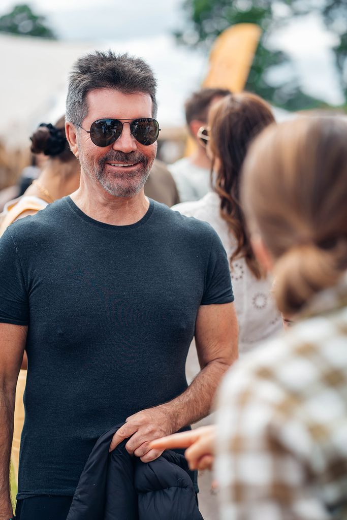Simon Cowell in a black tee and sunglasses