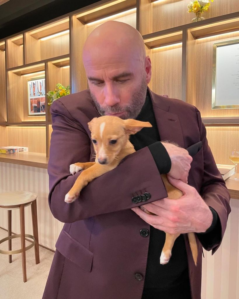 John Travolta with puppy Peanut at the Oscars in 2022