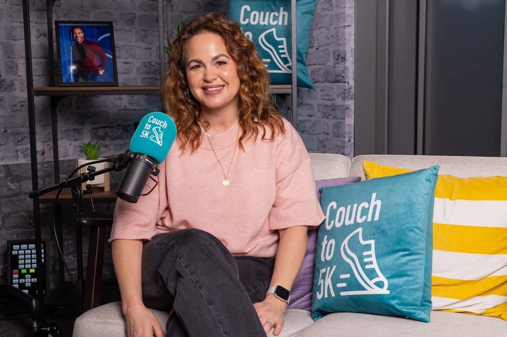 Giovanna on sofa with Couch to 5K Podcast mic and cushion