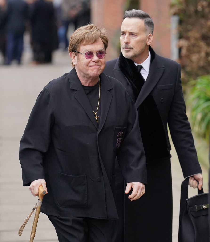 Sir Elton John and his husband David Furnish at the funeral service in Primrose Hill