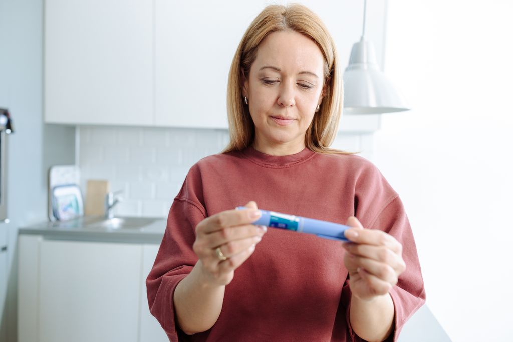woman holding ozempic pen