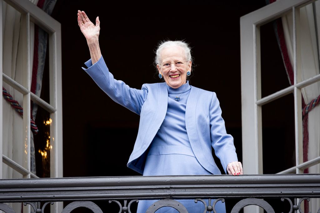 Queen Margrethe waving on a balcony
