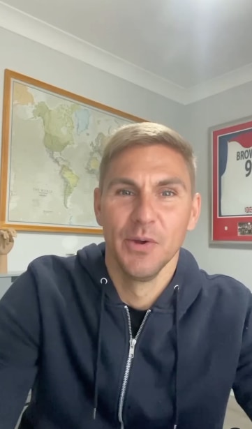 man in home office with map behind