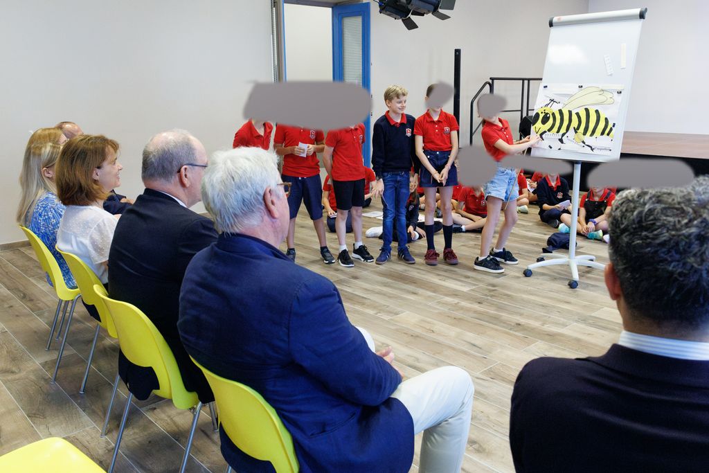 Prince Albert watching as Prince Jacques and a group of children speak about bees