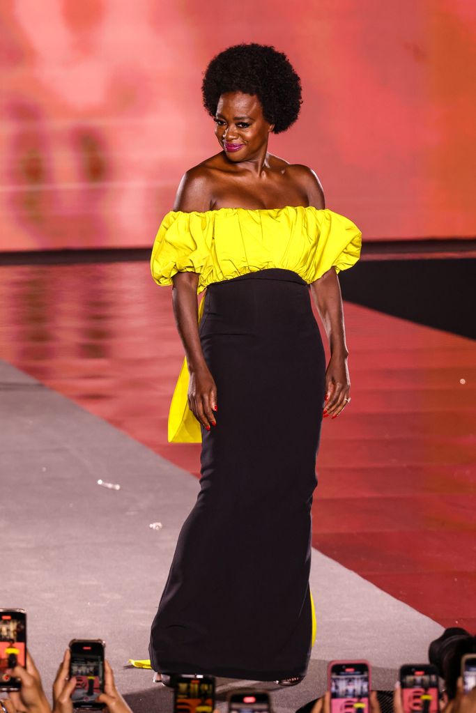 Viola Davis wearing a black and yellow dress during the L'Oreal show