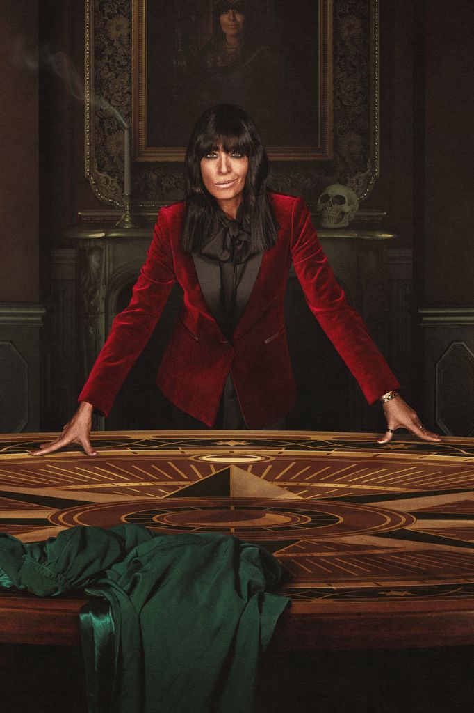 Claudia Winkleman wearing a red velvet suit on Celebrity Traitors