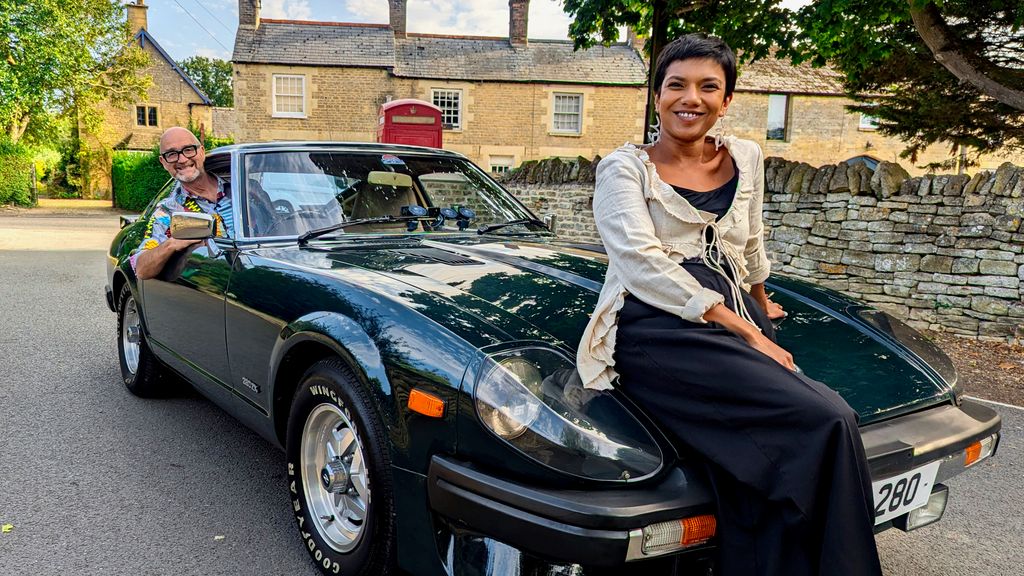 Woman sitting on hood of car, man in driving seat