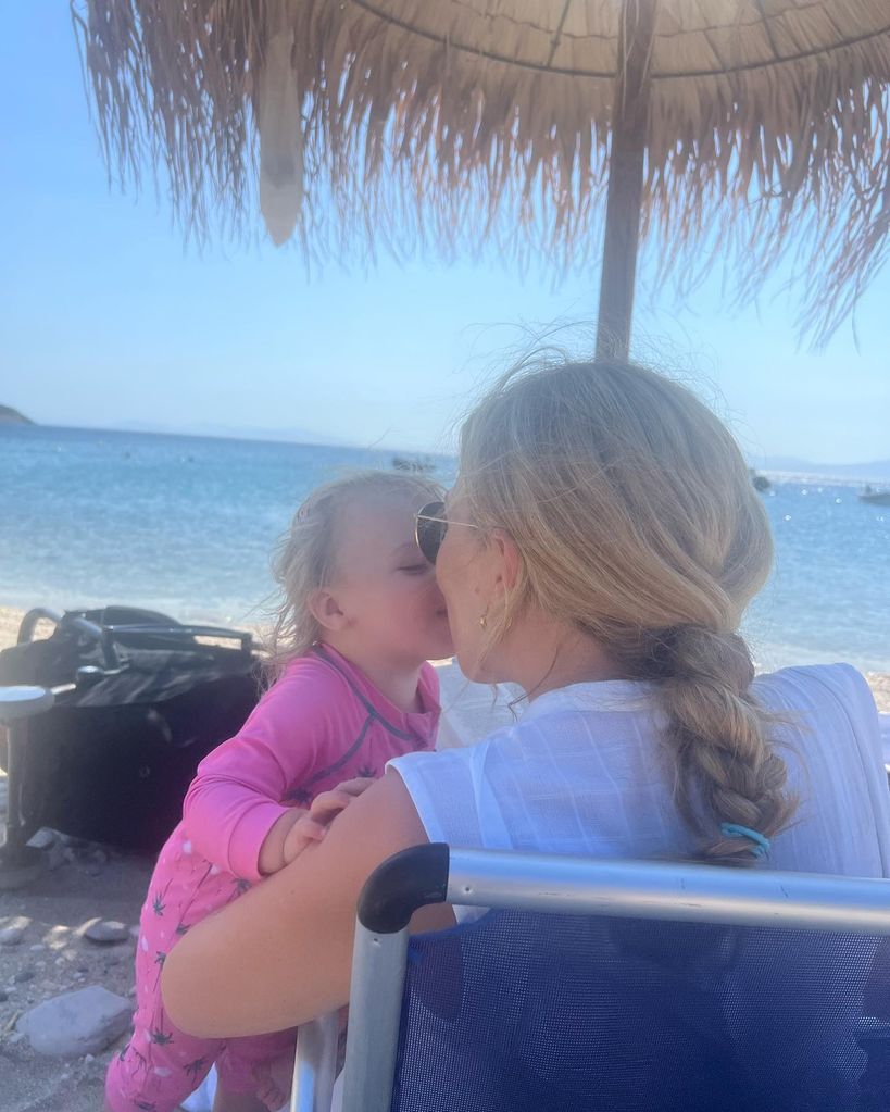 A photo of Romy Johnson kissing her moter Carrie on holiday