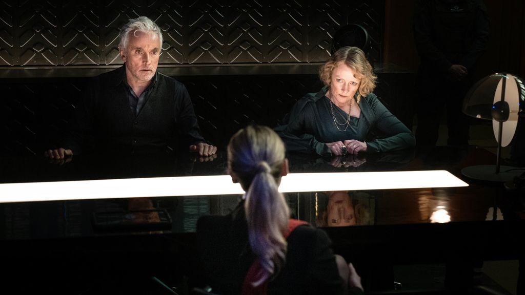 man and woman sitting opposite lawyer