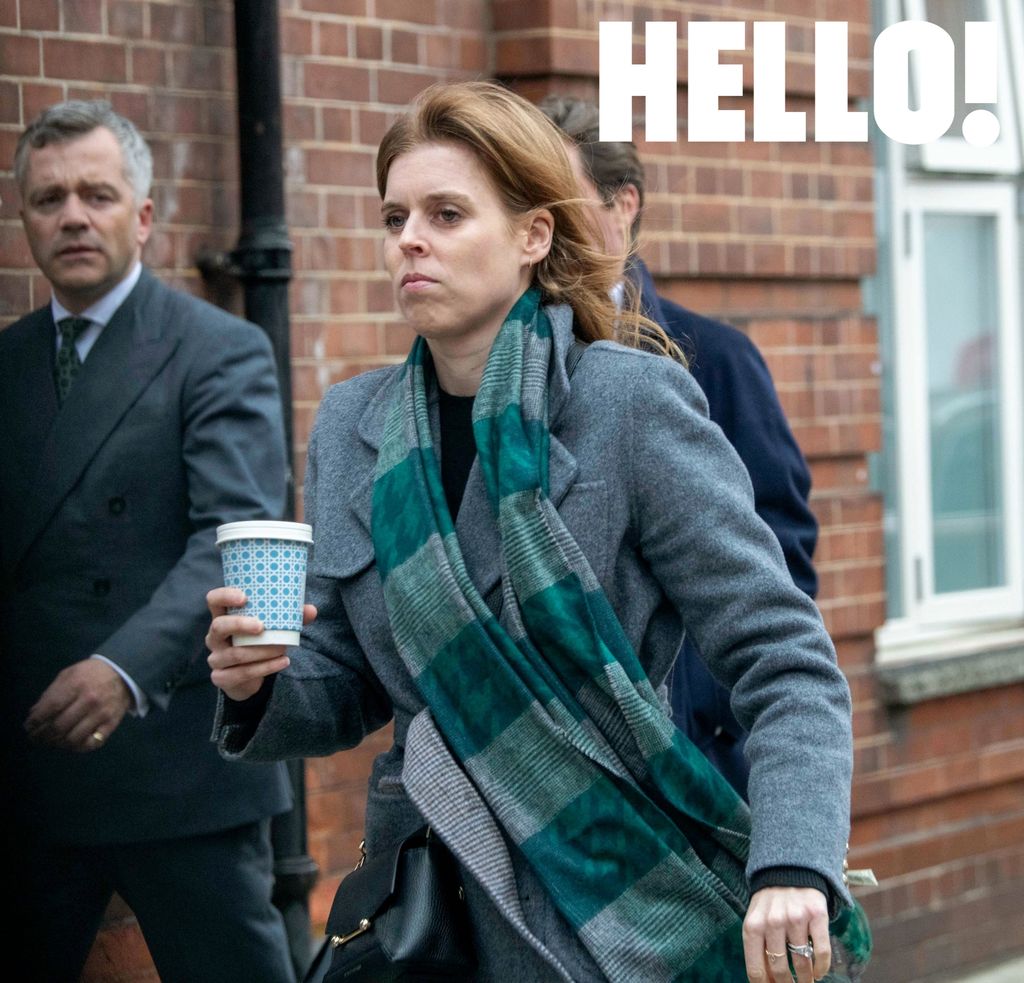 Princess Beatrice looking stern carrying a cup of coffee