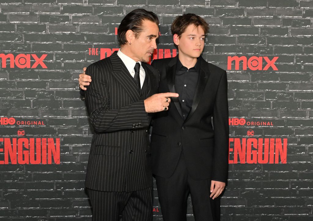 father and son posing at premiere 