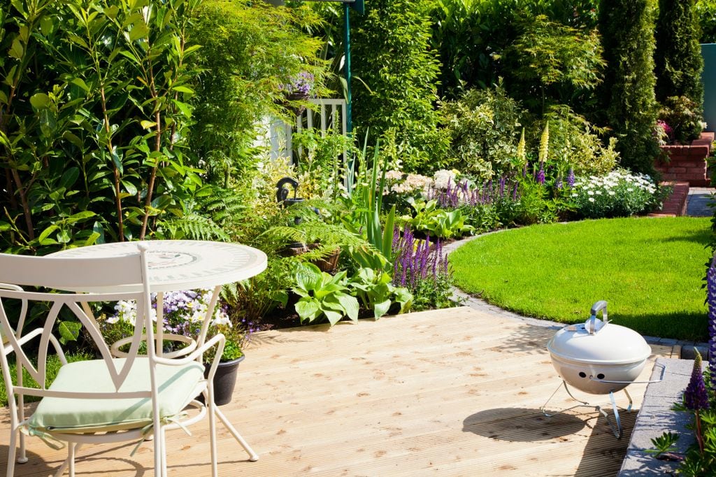 A garden with decking and circular lawn