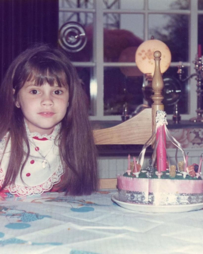 Victoria Beckham as a child with birthday cake