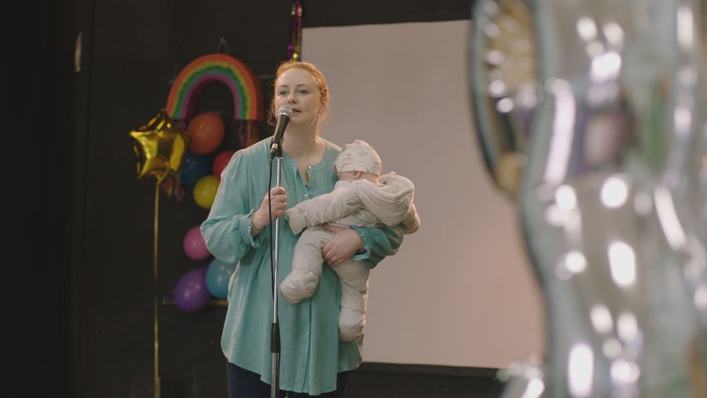 Philippa Dunne in Motherland carrying a baby