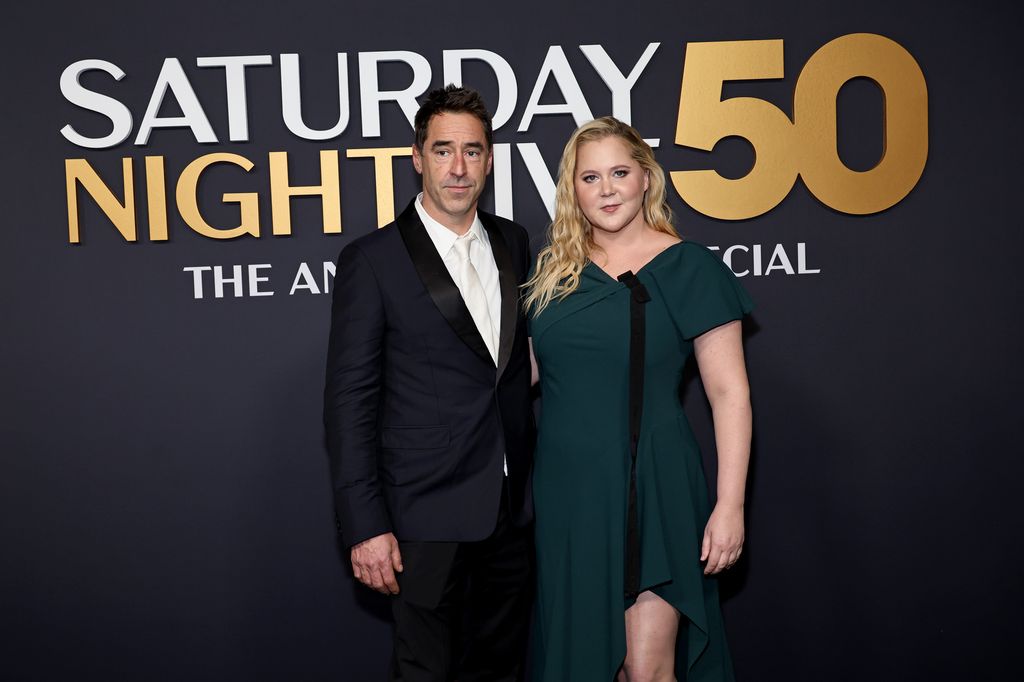 Chris Fischer in suit and Amy Schumer in green dress