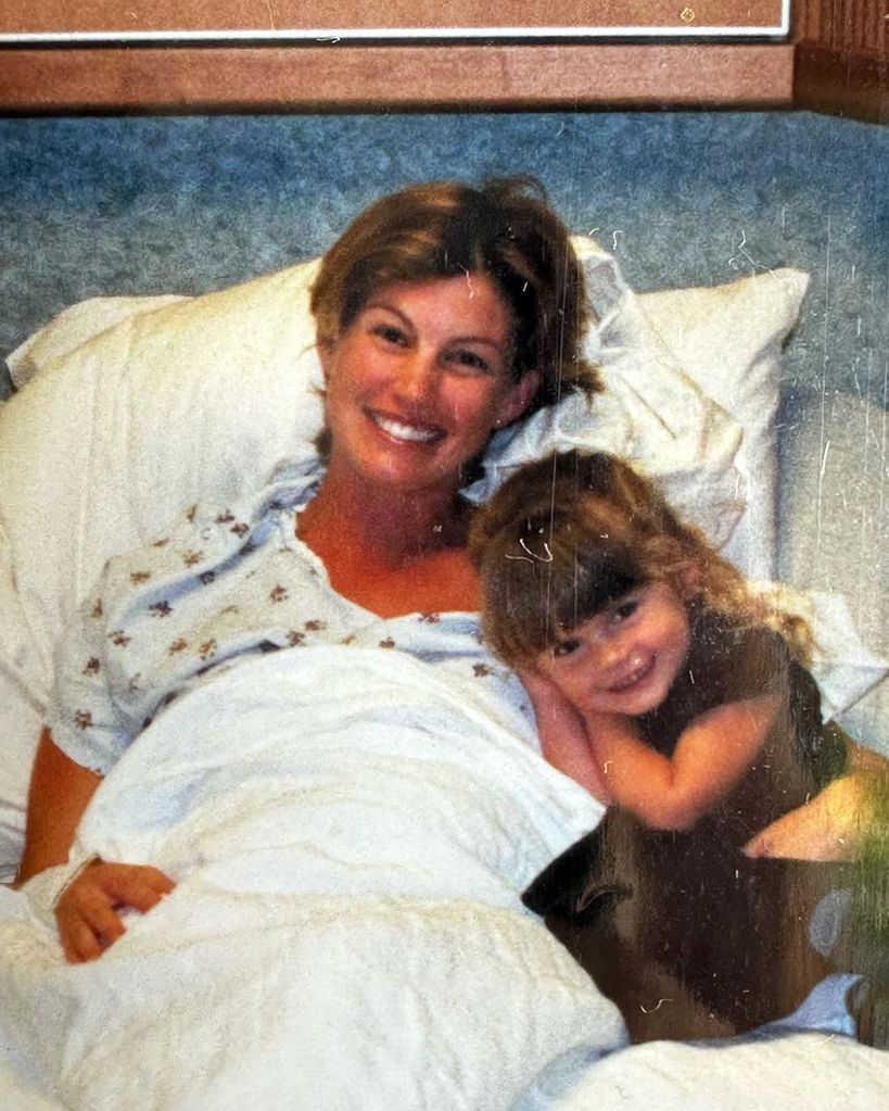 Faith Hill smiles next to her daughter Maggie