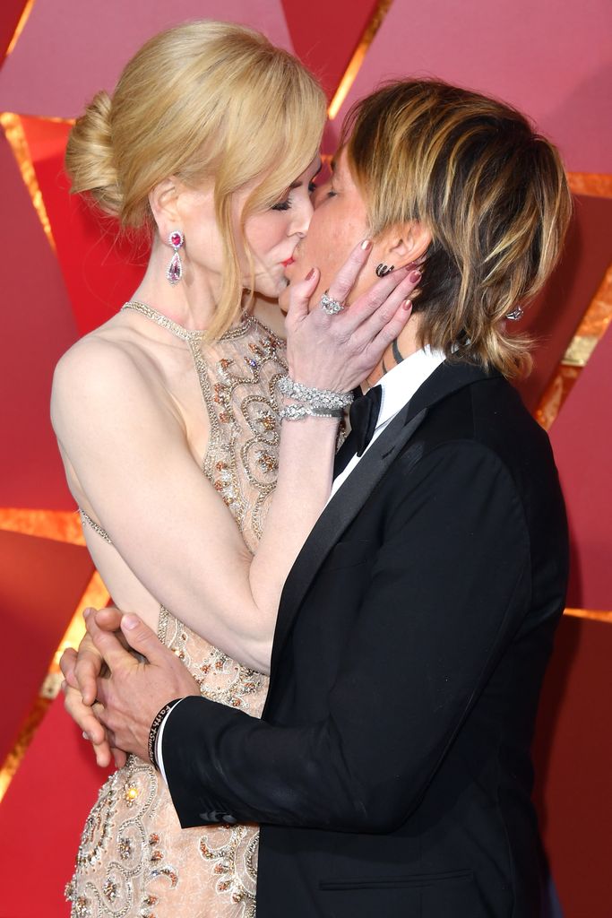 Actor Nicole Kidman (R) and singer Keith Urban kiss at the 89th Annual Academy Awards at Hollywood & Highland Center on February 26, 2017 in Hollywood, California.