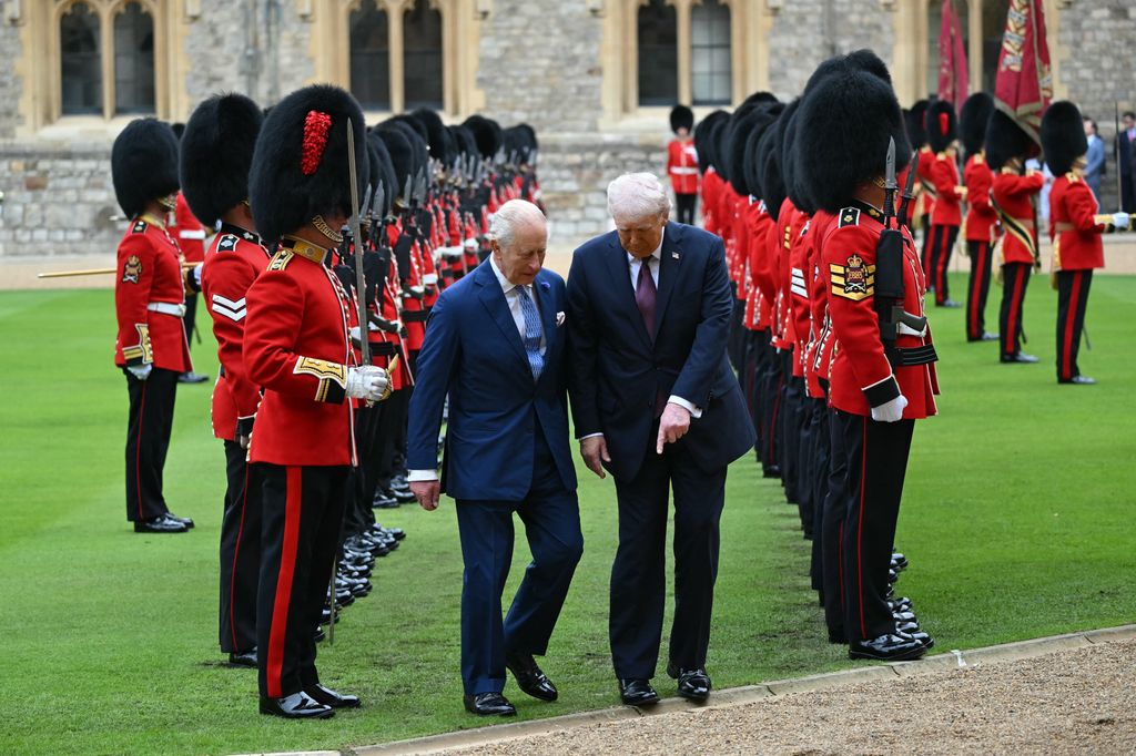 Britain's King Charles III (L) and US President Donald Trump (R) watch their step as they inspect the guard of honour during a ceremonial welcome in the Quadrangle at Windsor Castle, in Windsor