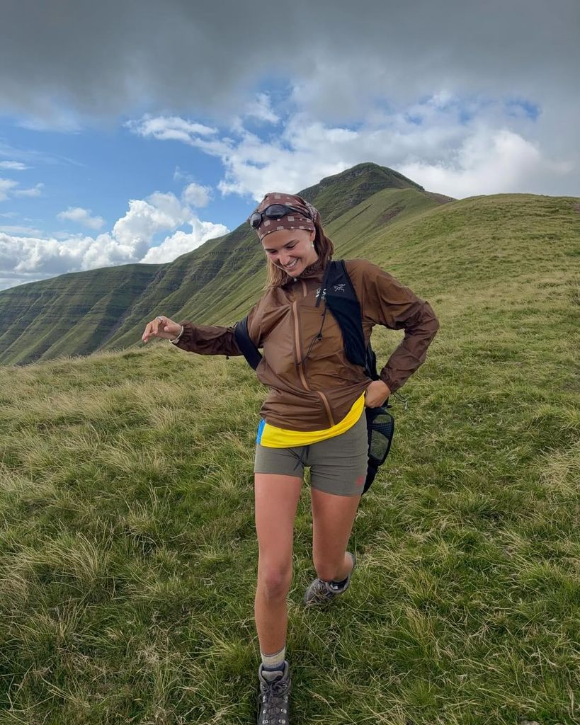 Mia Regan in shorts and brown waterproof jacket