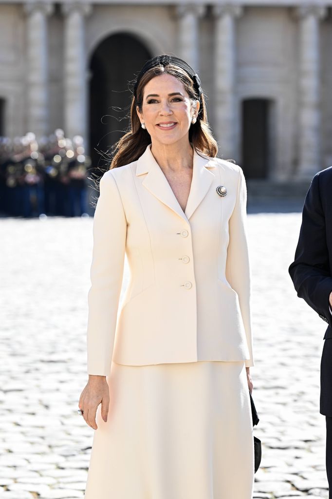 Queen Mary wearing cream skirt and headband