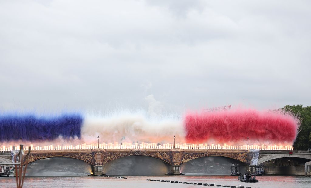 A general view as a Pyrotechnics Display in the colours of the National Flag takes place on the Austerlitz Bridge on the Seine during the opening ceremony of the Olympic Games Paris 2024 on July 26, 2024 in Paris, France. 