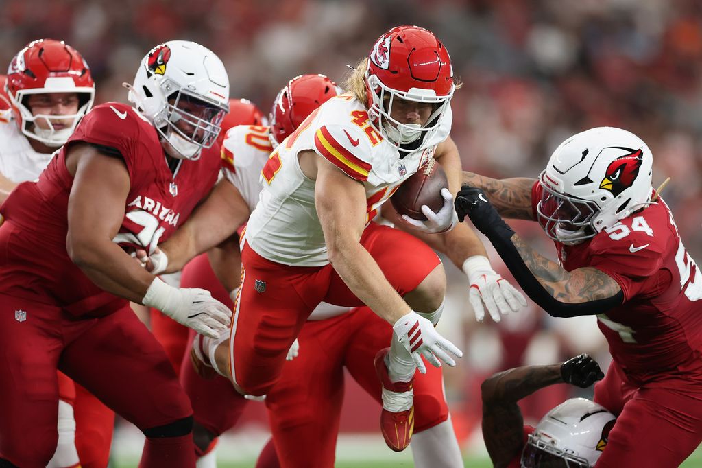 Fullback Carson Steele #42 of the Kansas City Chiefs rushes the football past linebacker Xavier Thomas #54 of the Arizona Cardinals during the second quarter of the NFL Preseason 2025 game at State Farm Stadium on August 09, 2025 in Glendale, Arizona.