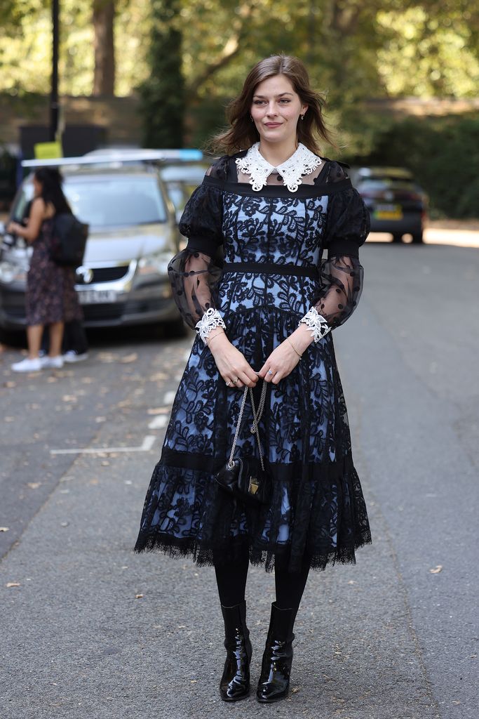 Guest wearing black laced dress with white lace collar and cuffs attends Bora Aksu at the Goodenough College during London Fashion Week September 2023 on September 15, 2023 in London, England. (Photo by Neil Mockford/Getty Images)