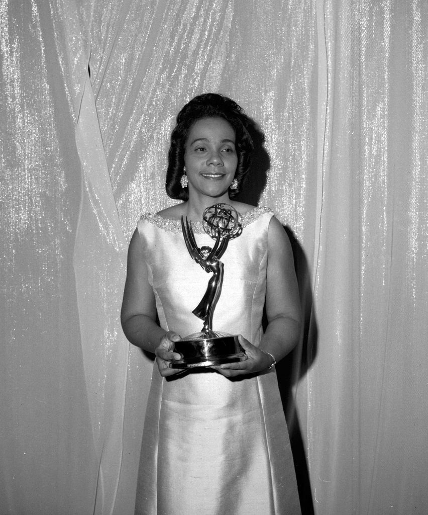 American civil rights activist Coretta Scott King (1927 - 2006) stands in front of a curtain with a statuette at the Emmy Awards, June 8, 1969. Among the presentations was a statuette to CBS for 'its intensive and sobering coverage' of Dr. Martin Luther King Jr.'s assassination.  Mrs. King commented: 'No matter how you measure it, 1968 was a most extraordinary year.'  (Photo by CBS Photo Archive/Getty Images)