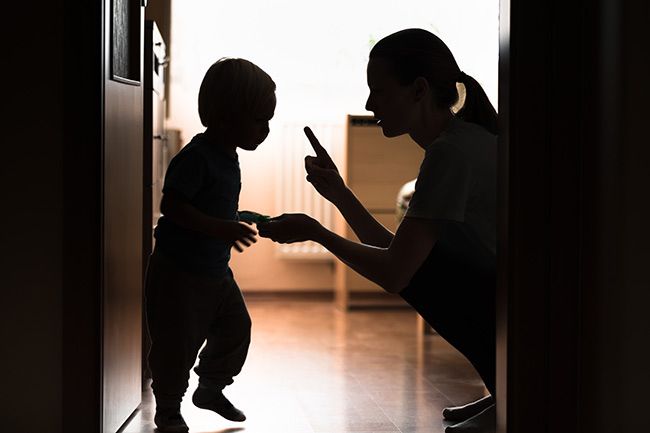 Parent disciplining a toddler