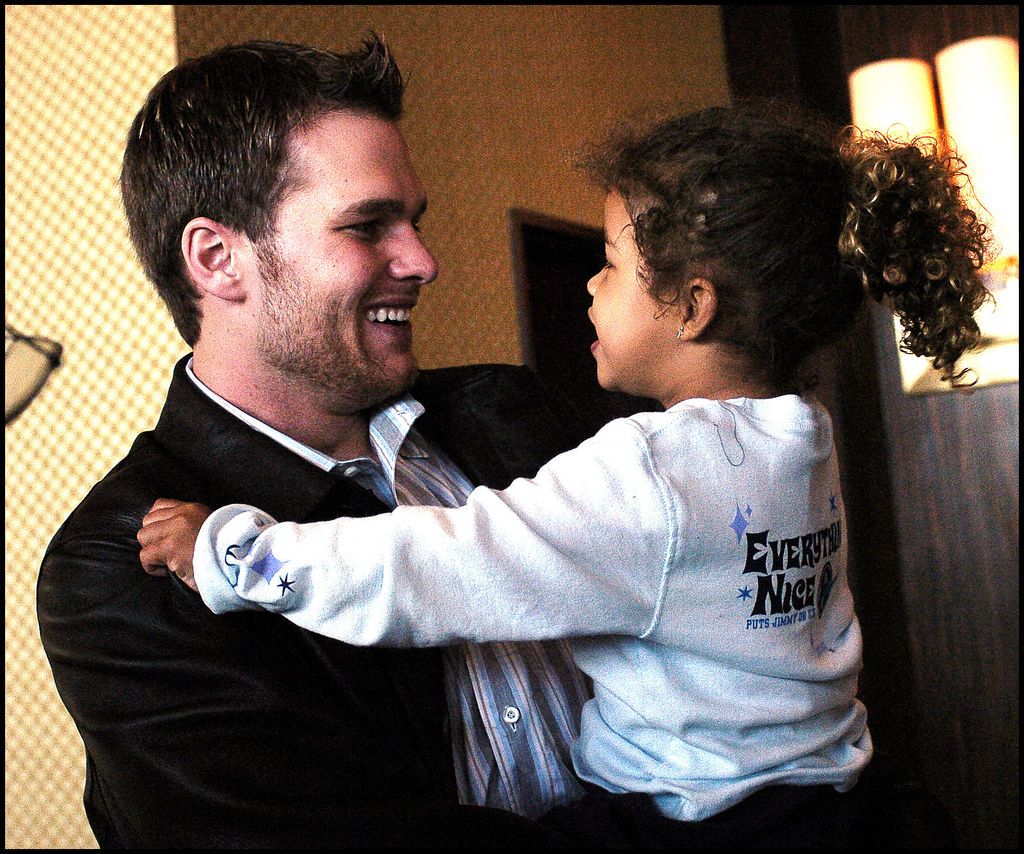 Tom Brady holding his neice Maya as a child