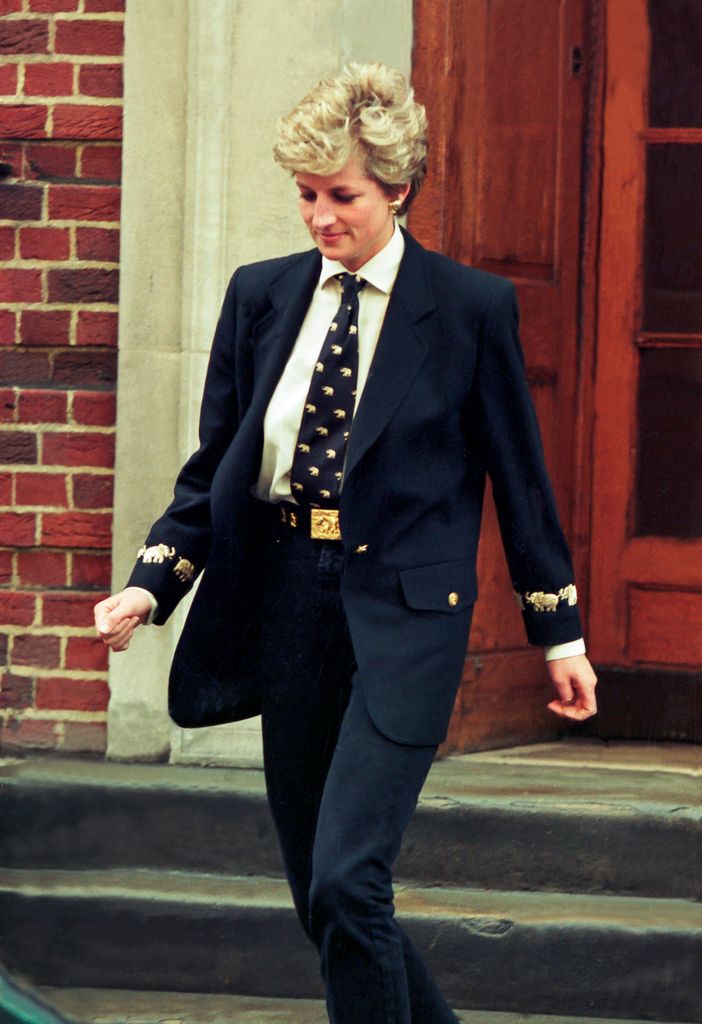 Princess Diana wearing a suit walking down steps