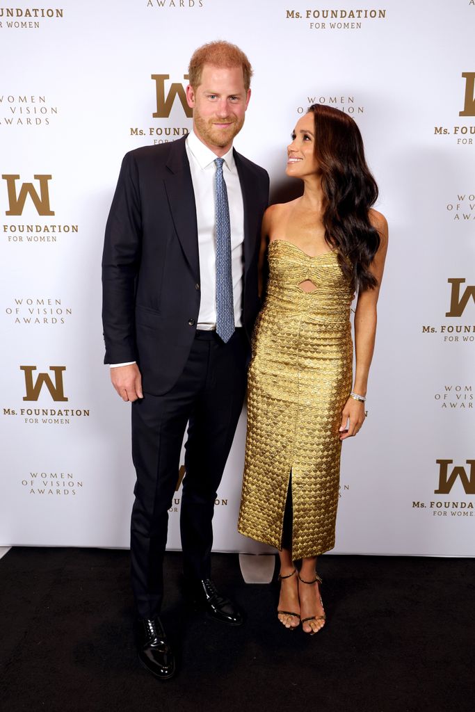 Meghan Markle in gold dress with Harry 