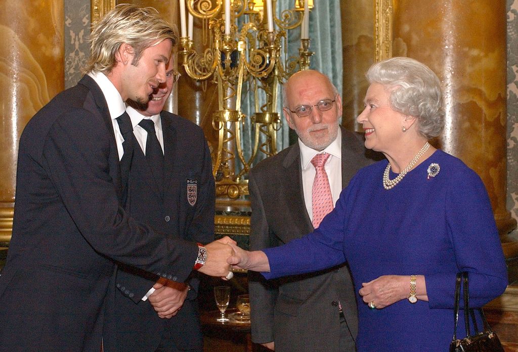 David Beckham shaking hands with the late Queen