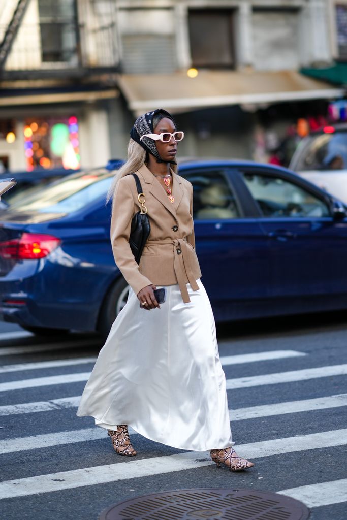 A guest at New York Fashion week wears a long white skirt