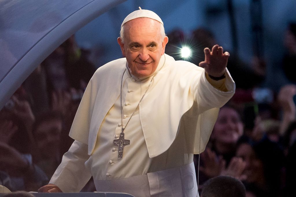 Pope Francis waves from the Popemobile on his way to attend the Via Crucis on Copacabana Beach during World Youth Day celebrations on July 26, 2013 